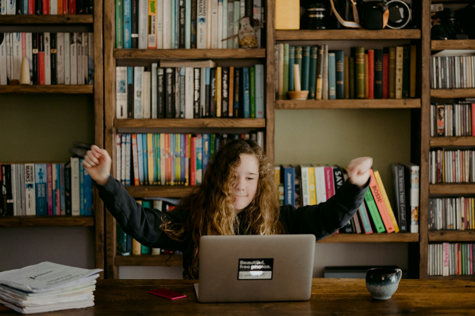 woman in black long sleeve shirt sitting in front of silver macbook for Rank My Course