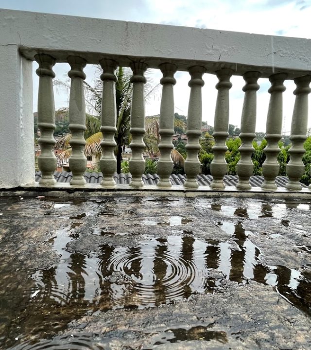 Photo by Andre Deniculi a view of a bridge over a body of water