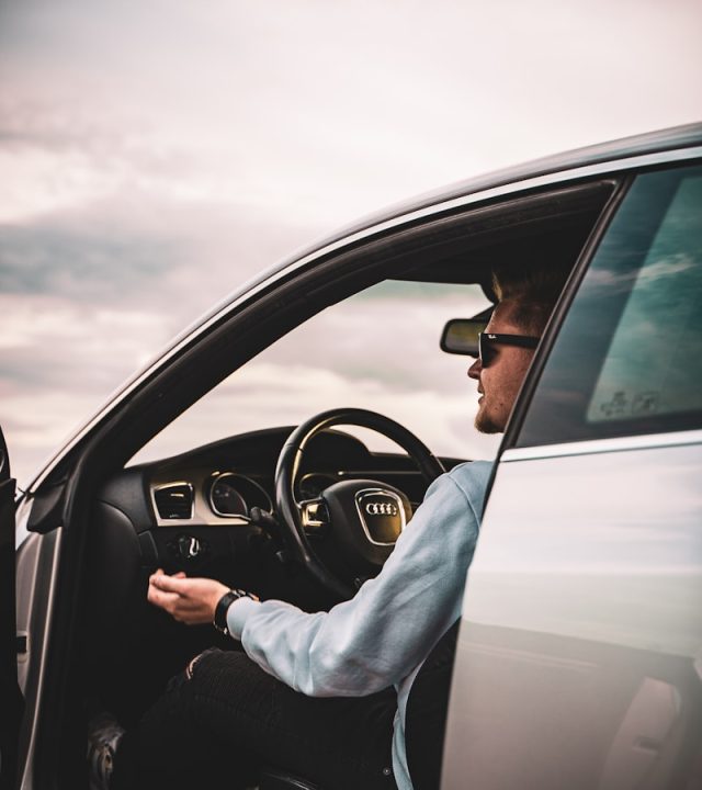 Photo by Fabio Henning person in gray long sleeve shirt driving car